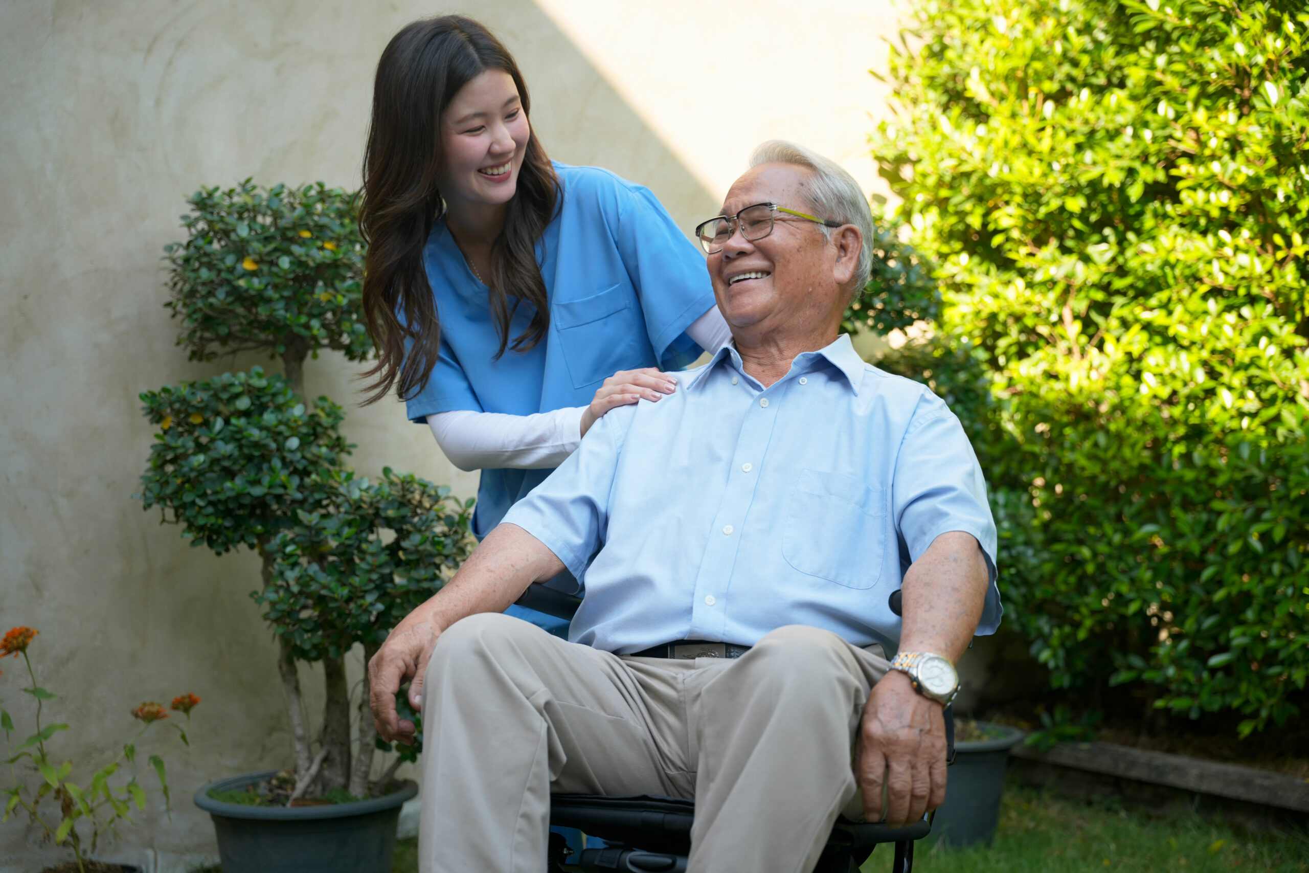 Caregiver assists elderly man outside in garden during sunny day Companion caregiver engaging with senior at home in Maumelle, AR – aged care support services Maumelle AR